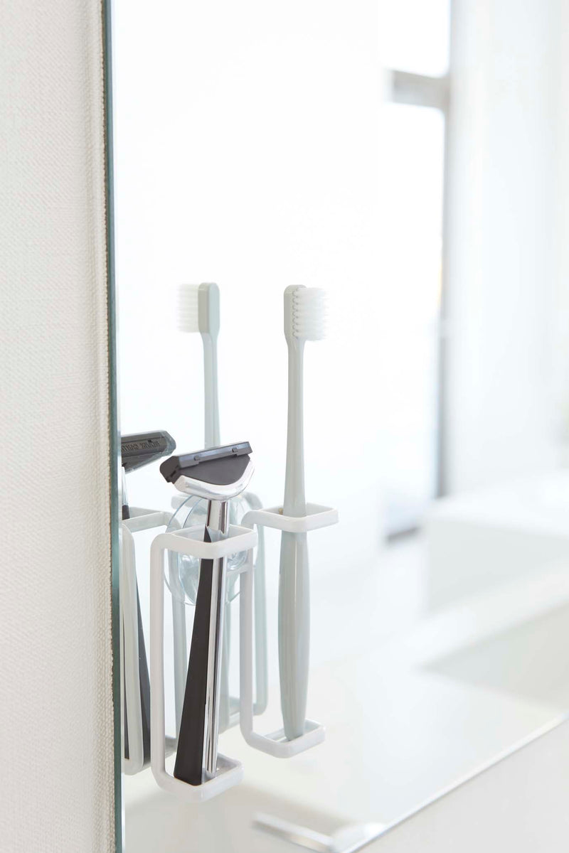 media image for Tower Suction Cup Mounted Toothbrush Holder by Yamazaki 270